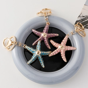 Starfish and seashell gold metal keychain with colorful enamel in pink and blue