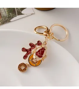 Close-up of golden toad keychain with red and yellow enamel and sparkling rhinestones