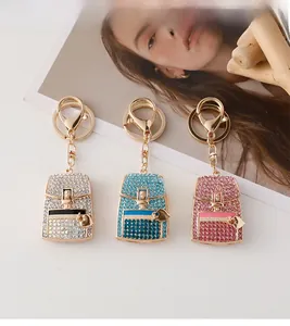Detailed close-up of crystal heart backpack keychains in silver, blue, and pink finishes