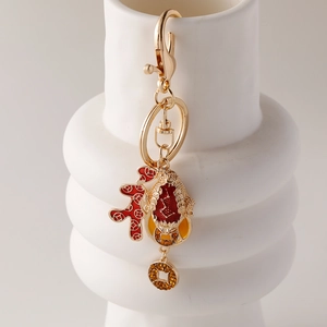 Chinese lucky golden toad keychain featuring a red coral pendant and rhinestone charm