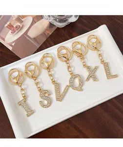 Detailed macro view of gold letter keychains with shimmering rhinestones and lobster clasp