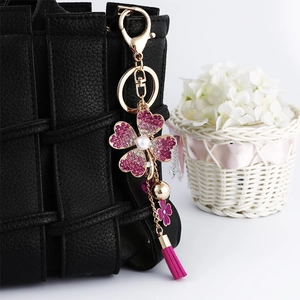 Sparkling four-leaf clover keychain with purple rhinestones and tassel for handbags