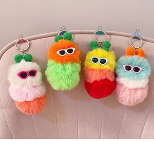 Detailed close-up of colorful plush caterpillar keychains with mini sunglasses and soft fur