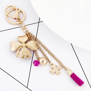 Golden flower keychain with pink tassel and rhinestones for women's handbag