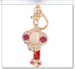 Macro detail of golden alloy Ruyi keychain with moonlight stone and sparkling rhinestones