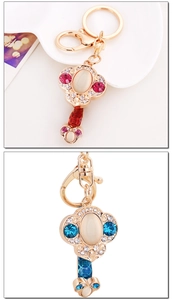 Close-up of Ruyi keychains with cat-eye stones, rhinestones and enamel details
