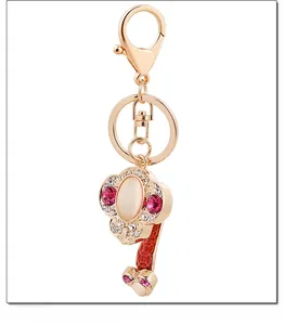 Macro view of rose gold ruyi keychain with pink crystals and smooth opal stone