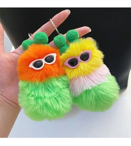 Detail view of colorful plush caterpillar keychains with mini sunglasses and silver ring