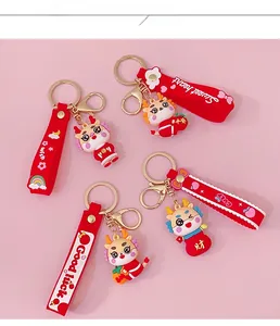 Detail of red cartoon dragon keychains with Good Luck wrist straps and gold metal rings