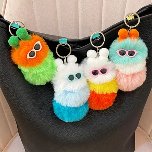 Cute colorful caterpillar plush keychain with sunglasses on black leather bag