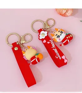 Detail of red cartoon dragon keychains with Sweet Heart wrist strap and gold clasp