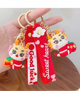 Detailed view of red 3D dragon keychains with silicone strap and gold metal rings
