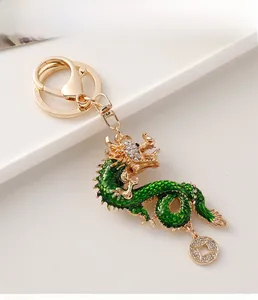 Detail of a Chinese dragon keychain with green enamel and sparkling rhinestones