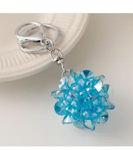 Détail macro du porte-clés boule de cristal bleue avec anneau en D et fermoir en métal argenté