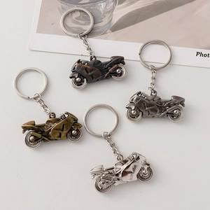 Metallic motorcycle model keychains in bronze, gun grey, gold, and silver finishes