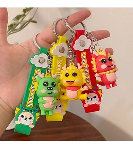 Close-up of colorful cartoon dragon silicone keychains with metal rings and wrist straps