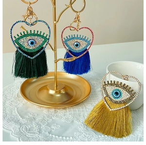 Détail du porte-clés coeur mauvais œil bleu avec glands colorés et strass scintillants