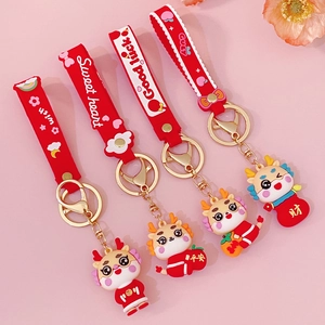 Set of four red and gold cartoon dragon keychains with festive wristbands for New Year