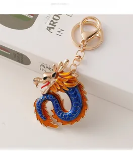 Close-up of golden Chinese dragon keychain with blue and orange enamel details