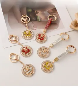 Detailed macro view of golden metal dragon keychains with colorful rhinestones set
