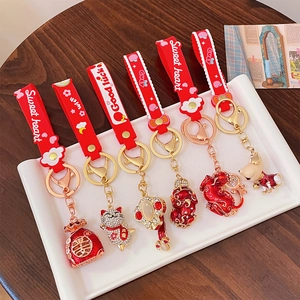 Set of six festive red silicone keychains with gold charms including Lucky Cat and Pixiu