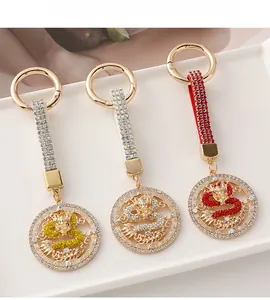 Chinese zodiac dragon keychains in gold, silver and red with crystal inlay details