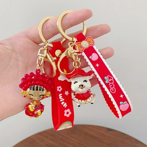 Festive Chinese New Year keychains with cute cartoon girl and pig lucky charms