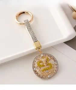 Macro detail of golden dragon keychain with sparkling crystal rhinestones and alloy finish