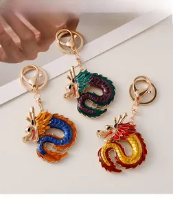 Detailed view of three dragon keychains with colorful enamel plating and gold metal finish