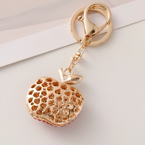 Creative gold apple keychain with red rhinestones and hollow texture for handbags