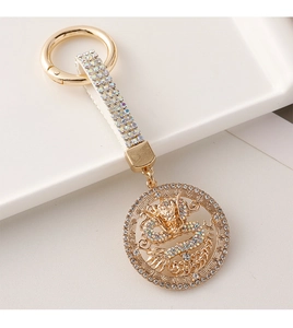 Detailed close-up of a luxury dragon keychain with colorful crystals and gold plating