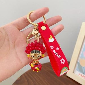 Festive red cartoon mascot keychain with gold ring and red rubber wish wrist strap