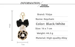 Detail view of camellia bow keychain with size dimensions and specifications list
