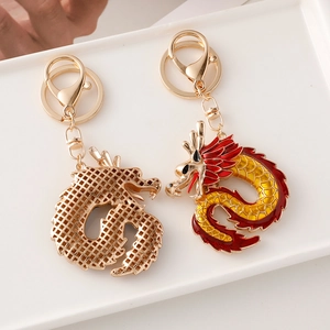 Chinese dragon keychains with gold hollow-out design and red enamel pendants