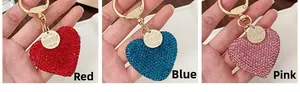Detailed close-up of sparkling rhinestone heart keychains in red, blue and pink colors