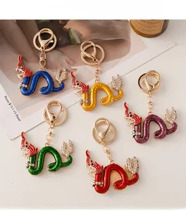 Set of five colorful dragon keychains with gold plating and glittering rhinestones