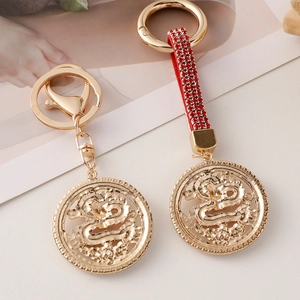 Exquisite golden Chinese dragon keychain set with hollowed disc and red rhinestones