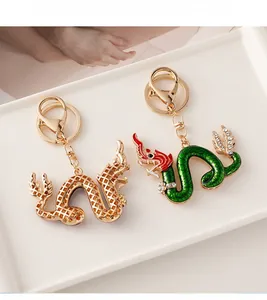 Detailed view of Chinese zodiac dragon keychains with gold mesh and green enamel finish