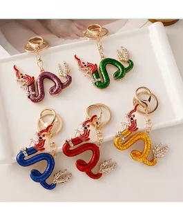 Detailed view of five colorful enamel dragon keychains with sparkling rhinestones set