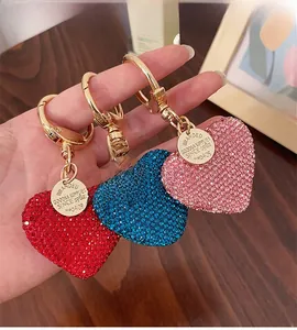 Close-up of sparkling heart-shaped rhinestone keychains in red, blue and pink colors