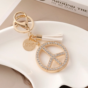 Golden peace sign keychain with sparkling rhinestones, white tassel and LOVE charm pendant