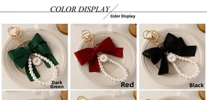 Detail view of large ribbon bow keychains with pearl strings in green, red, and black colors