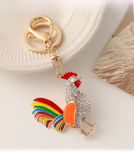 Detail of colorful rooster keychain with sparkling rhinestones and gold-plated alloy