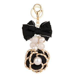 Elegant camellia and bow keychain with faux pearls and metal chain link detail