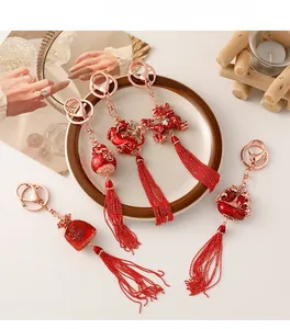 Detailed view of traditional Chinese New Year keychains with red tassels and gold charms