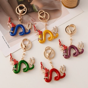 Golden zodiac dragon metal keychains with colorful enamel scales and sparkling rhinestones