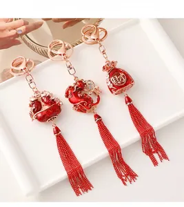Detailed view of Chinese style red tassel keychains with fortune bag and fish charms