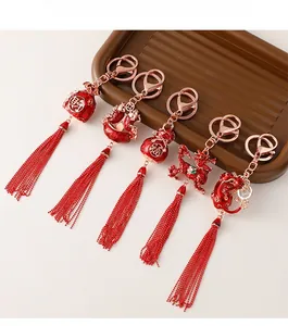 Close-up of Chinese New Year keychains with red tassels, fortune bags and dragon charms