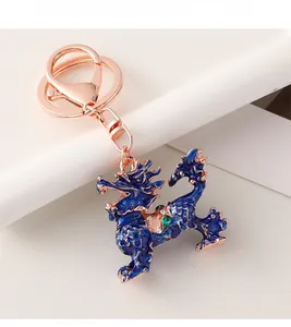 Macro detail of Chinese Kirin keychain with blue enamel and sparkling rhinestones