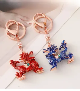 Detail view of dragon keychains with colorful enamel finish and green gemstone inlay